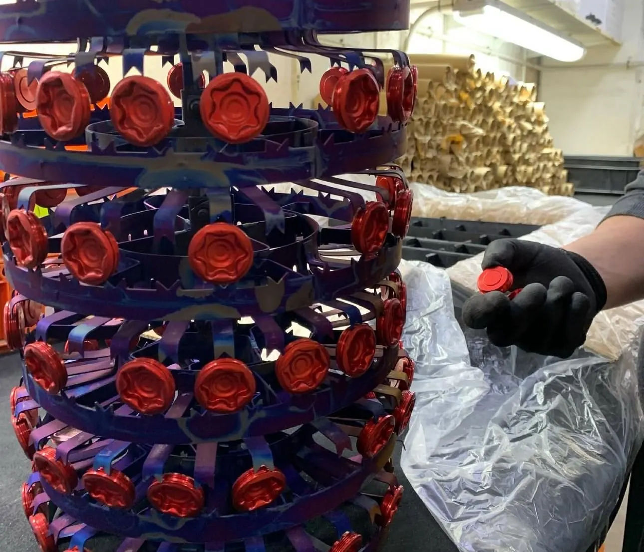 Desmontaje de tapones anodizados en rojo, retirados a mano del bastidor